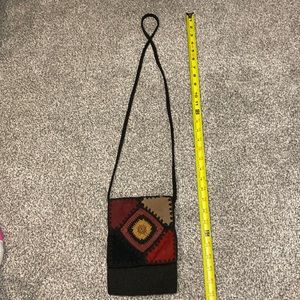 Crossbody purse black crochet with suede patches.